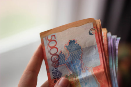 Thai Baht banknote in hand on blur background with bokeh