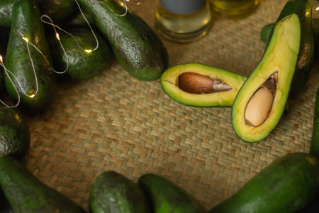 Avocado and avocado oil on a wooden background. Healthy food.の写真素材