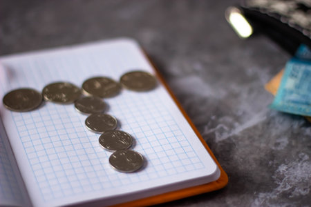 Coins and notebook on the table. The concept of saving money for the future.の写真素材