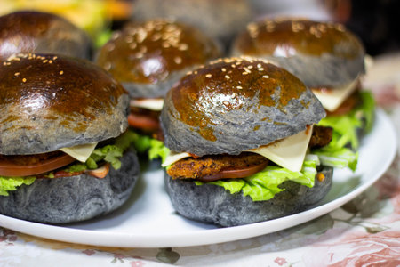 Hamburgers with meat and vegetables on a white plate.の写真素材