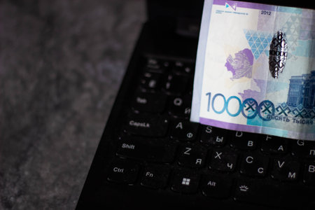 Close-up of Polish zloty banknote on laptop keyboardの写真素材