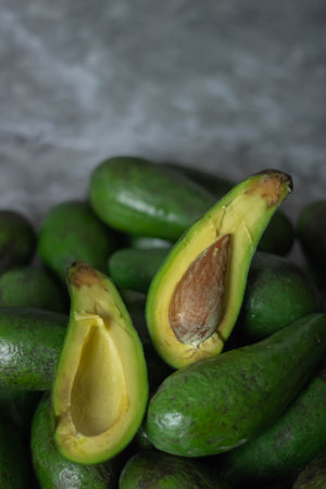 Avocado fruit on gray background. Healthy food concept. Selective focus.の写真素材
