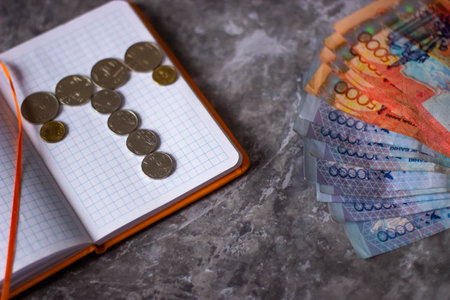 Coins and notepad on a marble table. Financial concept.の写真素材