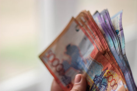 Thai banknotes in hand on blurred background with bokeh