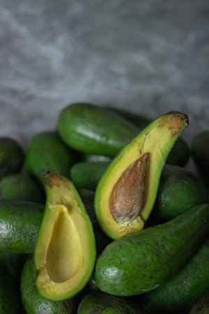 Avocado on the gray background. Healthy food concept. Selective focus.