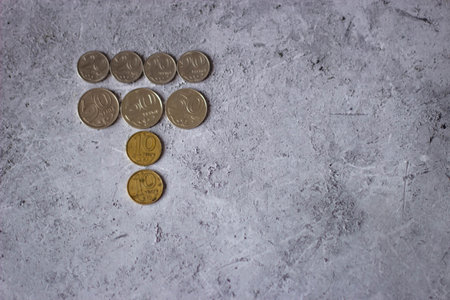 Coins in the form of a tree on a gray background.の写真素材