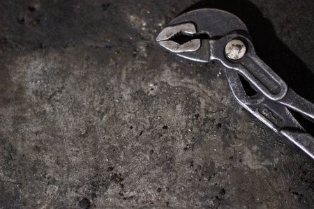 Old pliers on the black background. Close-up view.の写真素材