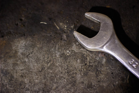 Spanner on a dirty metal background, close-up.の写真素材