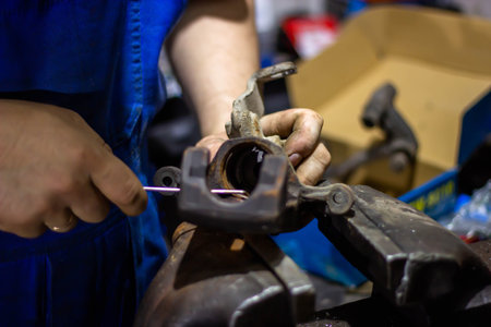 Close-up of the hands of an auto mechanic working in a workshop
