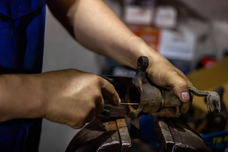Close-up of a man working in a workshop. Selective focus.の写真素材