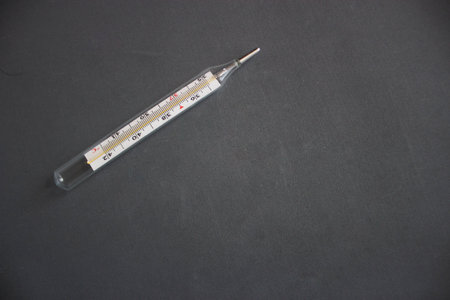 Medical thermometer on a black background. Thermometer on a black background.の写真素材