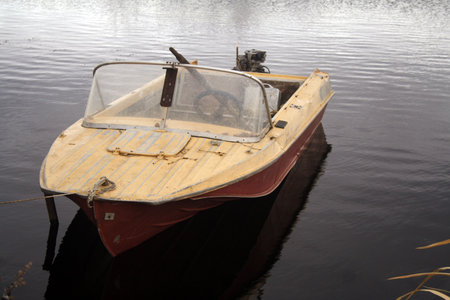 the faulty old boat with the pendant boat motor is at a mooringの写真素材