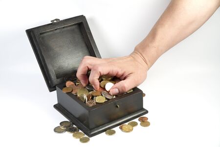 photo of a man stealing coins from a boxの写真素材