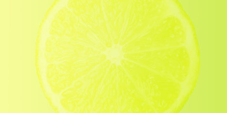 Summer, bright, yellow-green gradient background with a dissolving lemon wedge. food concept.の写真素材