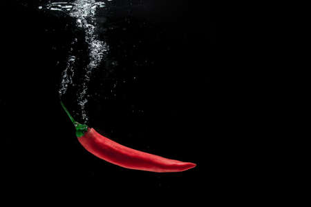 Red pepper with black background.の写真素材