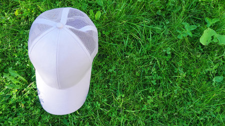 White baseball cap mock up on bench. Photo of blank hat for change design. Element for branding on...