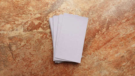 Business cards modern mock up. Deck of playing card on a brown and beige marble surface.Blank white cards or business cards. Branding and holidaysの写真素材