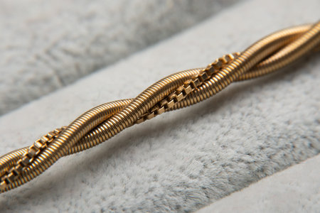 Gold chain necklace on grey, closeup.Gold chain details.