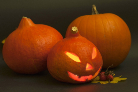 Three halloween pumpkins on black backgroundの写真素材