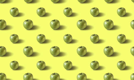Seamless fruit pattern with green apples on a yellow backgroundの写真素材