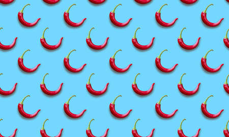 Seamless vegetable pattern with red chili peppers on a blue backgroundの写真素材