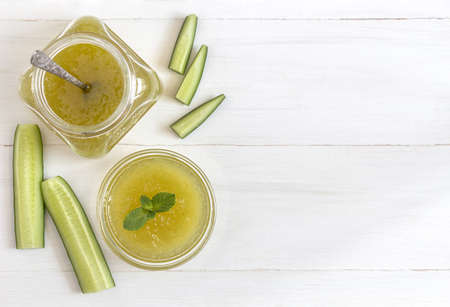 Flat lay of cucumber jam and cucumbersの写真素材