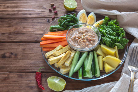 Salad with vegetables, eggs and tofu gado-gado on a wooden backgroundの写真素材