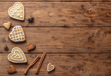 Heart shaped gingerbread cookie with icing on wooden backgroundの写真素材