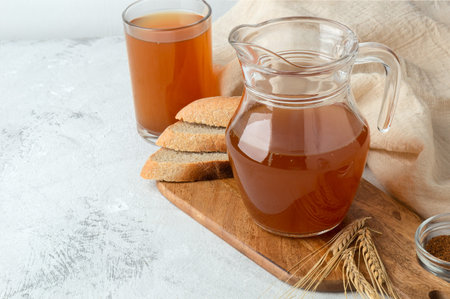 Cold kvass in a jug on a light table