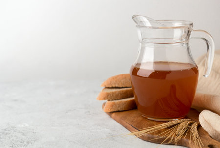 Jug with kvass on a white background. A traditional Russian soft drink with rye bread
