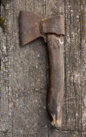 Old rusty ax on a wooden aged background. Flat layの写真素材