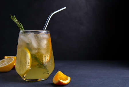 Soft drink with lemon and orange on a dark background. Place for textの写真素材