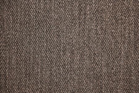 Gray dark uniform background resembling pebbles or small pebbles. Solid color wallpaper. Fine abstract texture. Simple background pattern. Monotonous surface of the walls.の写真素材