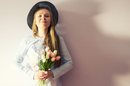 A young beautiful girl with blond dissolved long hair, a felt haの写真素材