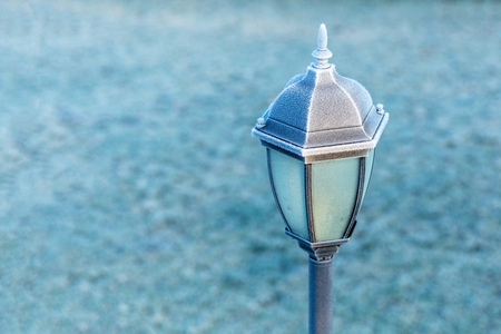 A black lighthouse near the house of the sun. First frost. Sunny weather. Copy space.の写真素材