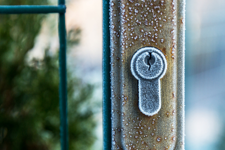 Gate with a lock covered with the first frost.の写真素材