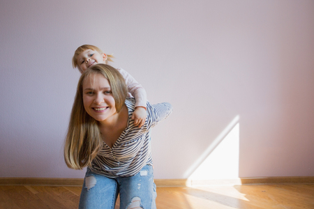 Happy family. Mom and daughter are playing in the room. Naturally laughed. Mother's Day.の写真素材