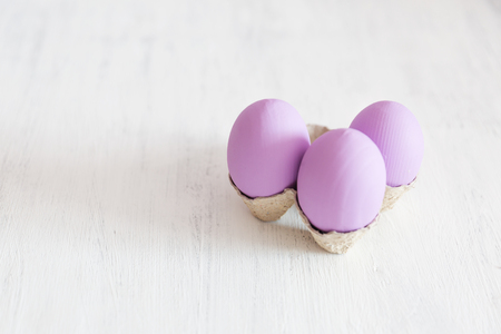 Easter postcard. Violet Easter eggs on a white vintage background. Copy space.の写真素材