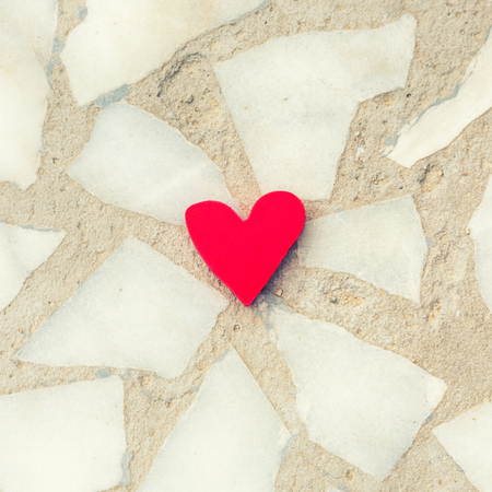 Red heart on marble background. Broken relations concept.の写真素材