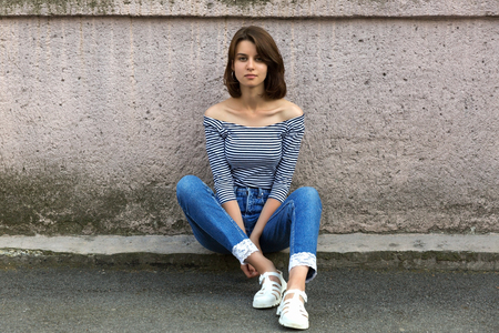 Young dreaming girl portrait. Old vintage wall, copy space.の写真素材
