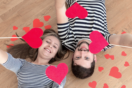 Top view young couple lying on the floor and looking to camera and smile.の写真素材
