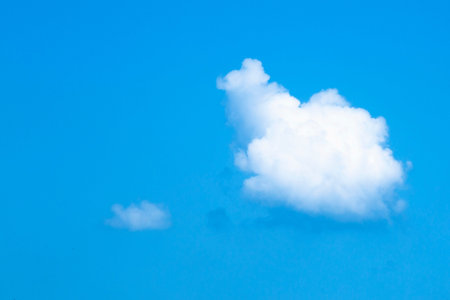 Clear blue sky with white cloudsの写真素材