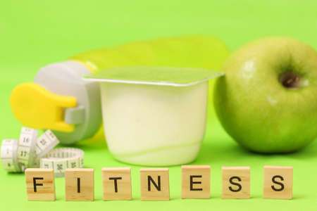 apple, yogurt and centimeter tape on green backgroundの写真素材