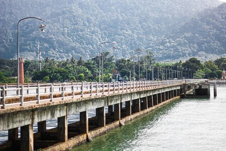 Koh Lanta Old Town Pier with old town district and the mountains in the background. View from the water boat.の写真素材