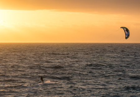 A man kitesurfing during a sunset in Indian ocean in Perth Western Australiaのeditorial素材