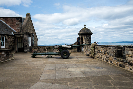 A gunner is cleaning One O'Clock gun in Edinburgh Castle, Scotlandの写真素材