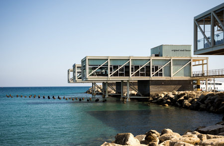 A steak house restaurant on posts hanging over water in Limassol Marina harbor, Cyprus