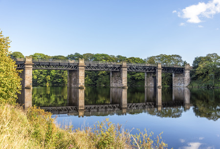 A scenic view of a bridge across river Dee near Duthie park, Aberdeen, Scotlandの写真素材
