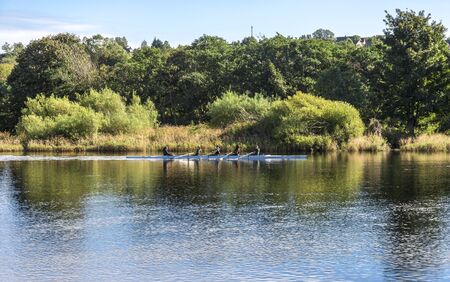 A group of sportsmen practicing in rowing in a four man kayak in river Dee, Aberdeen, Scotlandのeditorial素材
