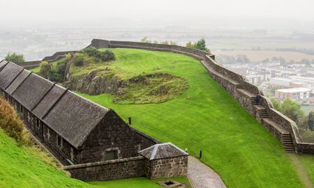 Stirling Castle yard with a green lawn, exhibition halls and stone walls to walk around in autumn rainy day, Scotland, Great Britainのeditorial素材